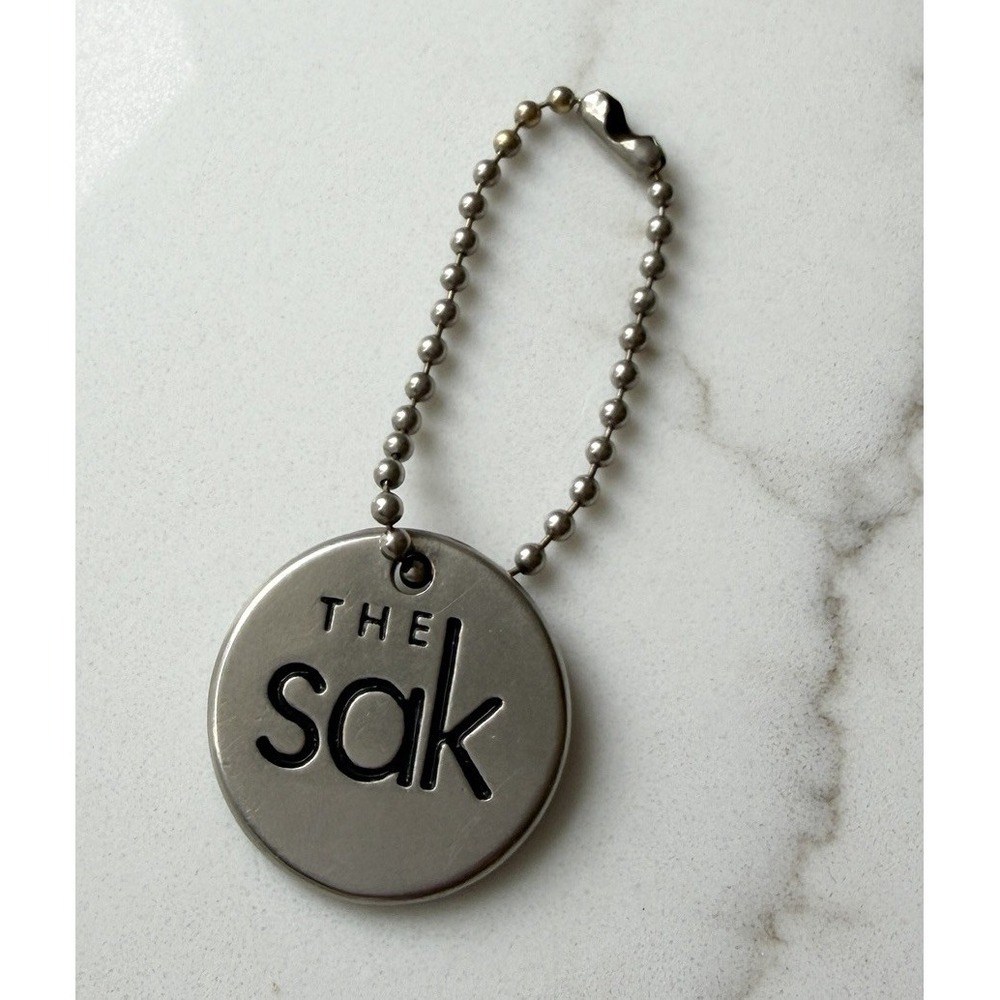 The Sak Purse Charm Keychain Silver Tone Logo Circle 1"